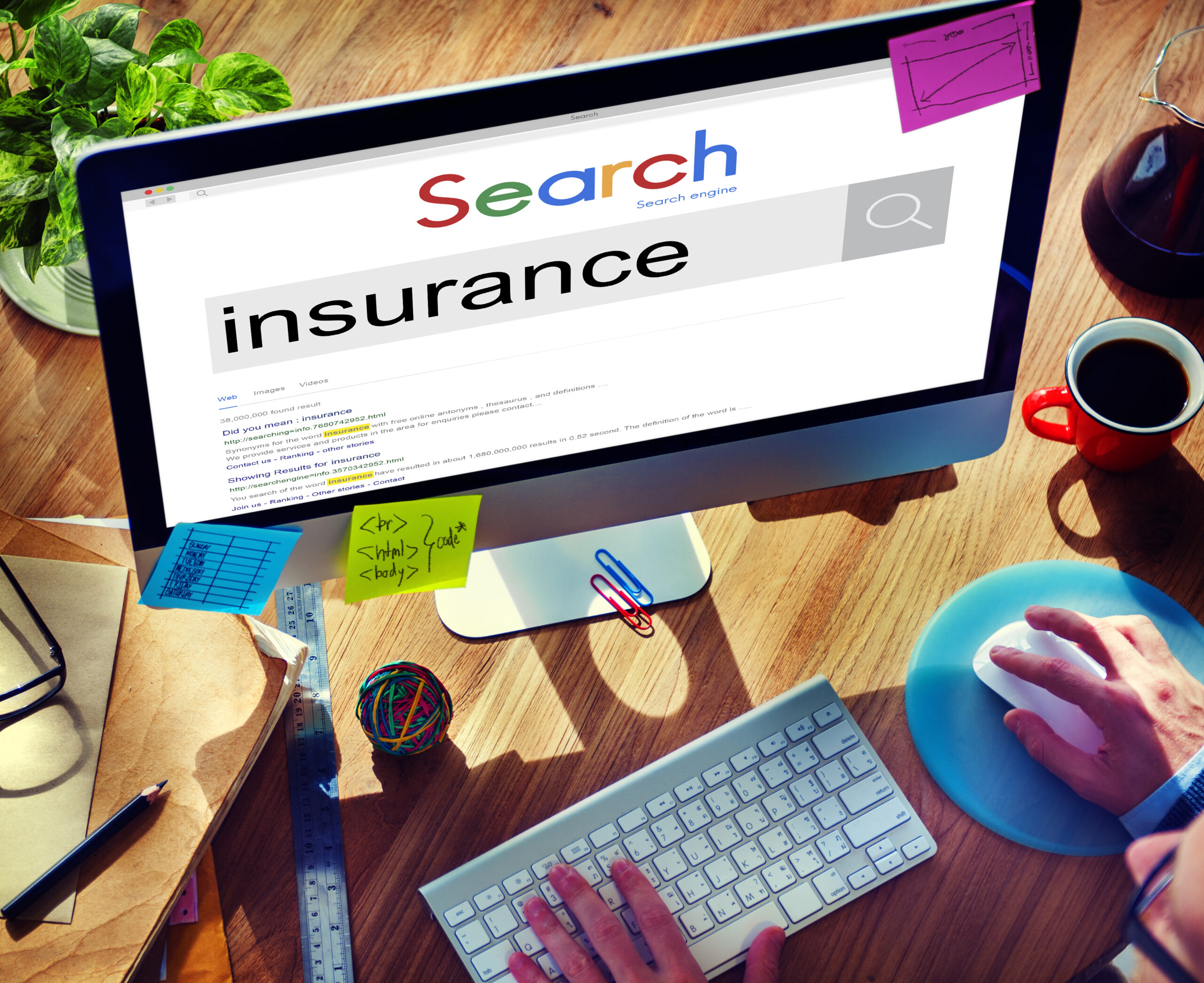 Person at computer researching bespoke home insurance